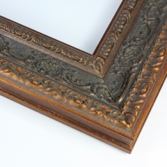 This large bronze with black Parisienne frame features highly decorative details on a wide 3 " profile. This vintage frame gives off a luxurious classic look that can elevate any artwork.