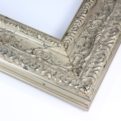 This vintage frame features highly decorative details. The moulding is silver with hints of black, giving it a classic look.